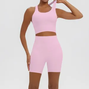 Pink seamless yoga set detail, breathable fitness crop top and high waist shorts.