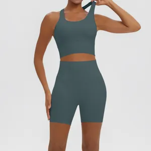 Detail view of women athletic yoga set featuring crop top and high waist shorts activewear.