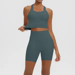 Detailed view of women's solid color athletic crop top and high waist biker shorts set.