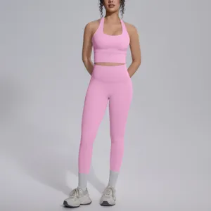 Roze tweedelige yogaset met halter crop top en hoge taille leggings voor fitness en training.
