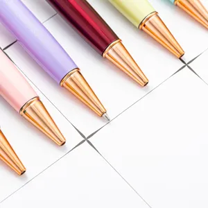 Colorful metal ballpoint pens with rose gold tips, elegant stationery for office and school.