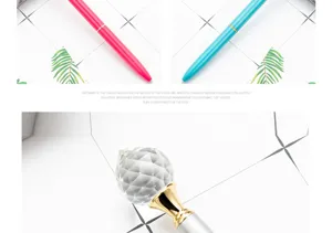 Detailed view of the luxury metal ballpoint pen featuring a sparkling crystal diamond top.