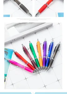 Detailed view of colorful gourd push ballpoint pens arranged neatly on grid background.