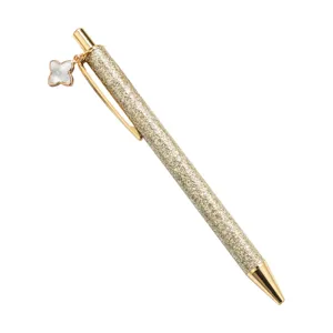 Gold glitter ballpoint pen with elegant four leaf clover charm, luxury metal click writing pen.