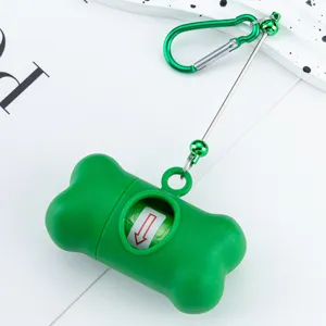 Dog waste bag dispenser bone-shaped with carabiner and retractable leash for outdoor walking.
