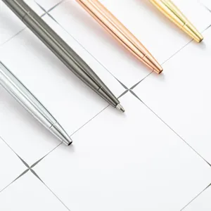 Set of 4 metallic ballpoint pens in assorted colors for office and school stationery.