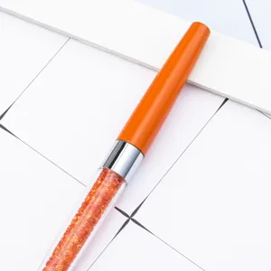 Crystal bling ballpoint pen with orange cap and sparkling rhinestones for office stationery use.