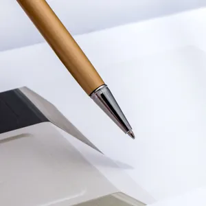 Elegant metallic ballpoint pen with golden body and silver tip for office and school use.