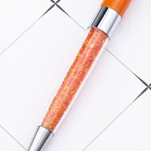 Crystal filled metal ballpoint pen with orange top and silver accents for office school use.