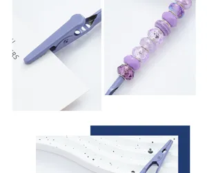 DIY beaded metal alligator memo clip and name card holder detail view with purple faceted beads.