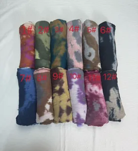 Detail view of colorful modal rayon printed headscarf with tie dye marble patterns.