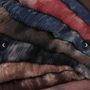 Detailed view of soft modal tie-dye crinkle scarf texture, showing vibrant color gradients.