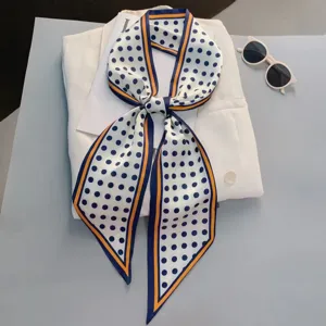 Elegant polka dot silk scarf detail, versatile narrow neck ribbon or stylish hair accessory.