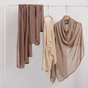 Detailed view of lightweight modal cotton solid color women scarves hanging on a rack.