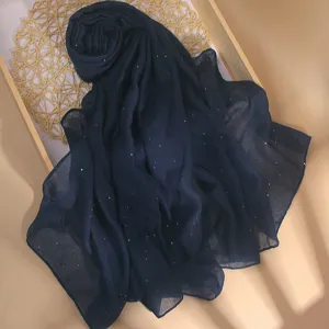 Detailed view of the dark blue sequin scarf, featuring soft breathable fabric and shiny details.