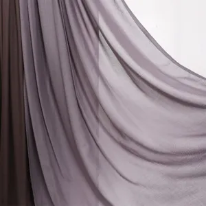 Detail shot of a solid color modal rayon scarf showing soft draped fabric texture and double-needle hem.