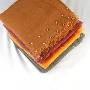 Solid color cotton linen scarf with pearl beaded details and frayed edges, wrinkled hijab.
