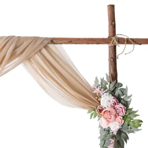 Wedding arch chiffon drapery fabric and artificial rose floral decor set for ceremony.