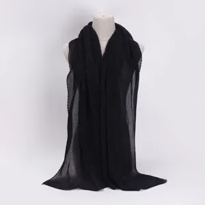 Detailed view of the black pleated shimmering metallic crinkle fashion scarf texture.