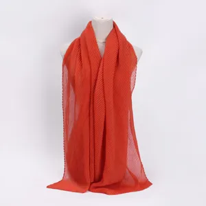 Orange pleated scarf for women, lightweight crinkle cotton blend fashion neck wrap detail.