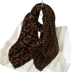 Women's pleated fashion scarf in brown and black monogram pattern, cozy autumn winter wrap.