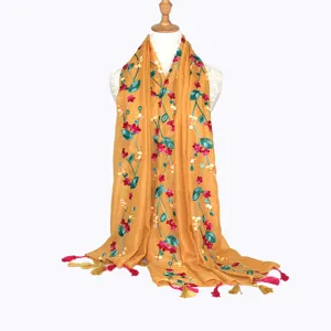 Detailed view of the yellow embroidered floral scarf showing delicate tassels and ethnic style.