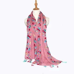 Floral embroidered linen scarf shawl detail showing delicate colorful patterns and cute tassels.