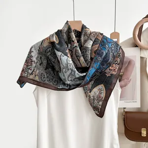 Elegant vintage paisley print square silk scarf draped on mannequin, main fashion shot.
