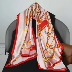 Elegant pink silk scarf featuring classic equestrian harness prints, perfect for spring fashion.