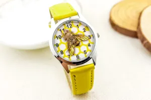Detailed view of children quartz watch with yellow leather strap and honeycomb bee dial.