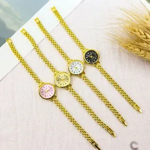 Women's small dial quartz watch with gold chain strap, minimalist fashion detail view.