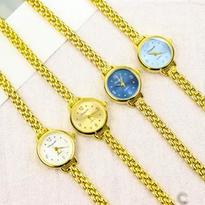 Close-up detail view of minimalist women quartz watch with metal link strap and small dial.