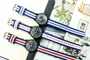 Kids nylon strap quartz watch with luminous military dial and colorful striped wristbands.