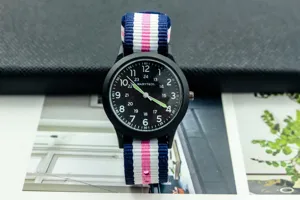 Detail view of casual children student military quartz watch with colorful striped nylon strap black dial