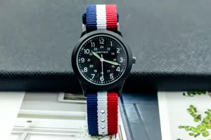 Casual nylon strap quartz watch with black dial, luminous hands, and Arabic numerals for daily wear.