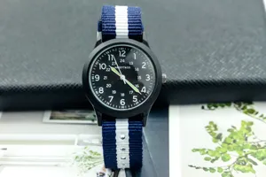 Black dial nylon strap military quartz watch detail, luminous hands, casual student wristwatch