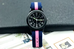Classic military style quartz watch featuring a blue and pink nylon strap and clear luminous dial.