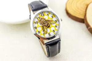 Kids quartz wristwatch featuring a 3d bee and honeycomb dial with black leather strap.
