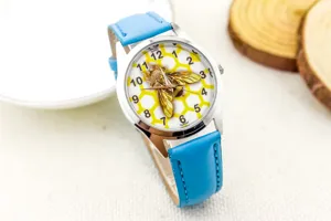 Detailed view of children quartz watch with blue leather strap and 3d bee honeycomb dial.