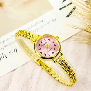 Elegant small dial gold quartz watch featuring a pink face and delicate chain strap detail.