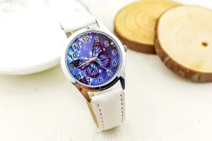 Detail view of children's white leather strap quartz watch with colorful butterfly dial design.