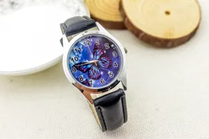 Kids quartz watch with black leather strap and beautiful blue butterfly dial design for children.