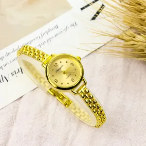 Elegant minimalist small dial quartz watch for women, chic gold chain bracelet design.