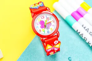 Close-up detail of children red quartz watch with cute 3D butterfly design and colorful dial.
