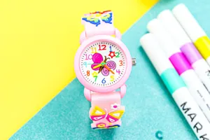 Close-up detail of the cute 3D pink butterfly kids quartz watch with colorful dial numbers.