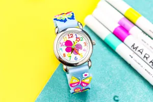 Children quartz watch detail featuring a cute 3d butterfly silicone strap and colorful dial.