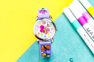 Kids 3D butterfly quartz watch detail, vibrant colorful dial, cute purple silicone strap.