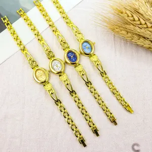 Vintage gold bracelet watch with small oval dial and cute heart strap, quartz movement detail.