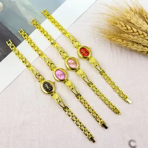 Detailed view of vintage women oval dial quartz watch with heart chain strap in multi colors.