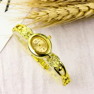 Women retro quartz watch oval dial heart bracelet strap elegant golden wristwatch detail